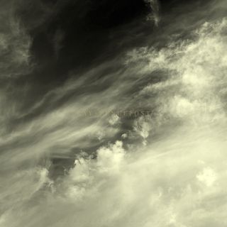 A warm-toned black and white image of the sky, featuring long, wispy clouds beginning at the lower left and moving up toward top right. There are also clouds like cotton balls and others that are less defined. In the background, the sky appears in multiple shades. The text RAY + FENCEPOST appears in the center in a light colored font, and at the bottom in a script typeface appears the text The Breath Behind My Eyes.